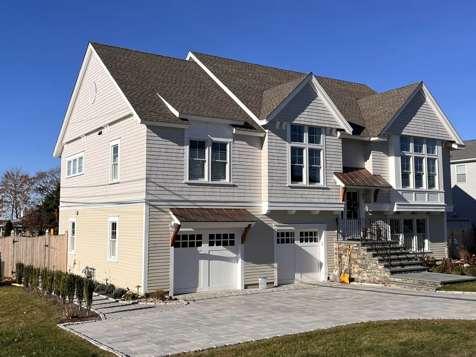 New Middletown home with architectural shingle roof, copper entry accents and clean rooflines