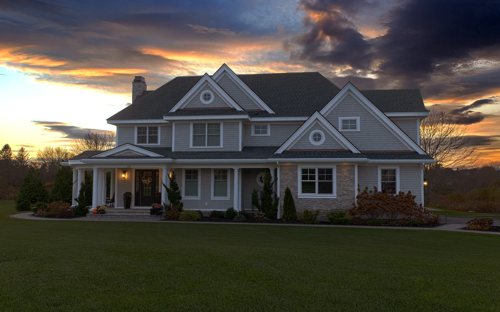 New construction custom home in Portsmouth RI by PJR Construction at dusk